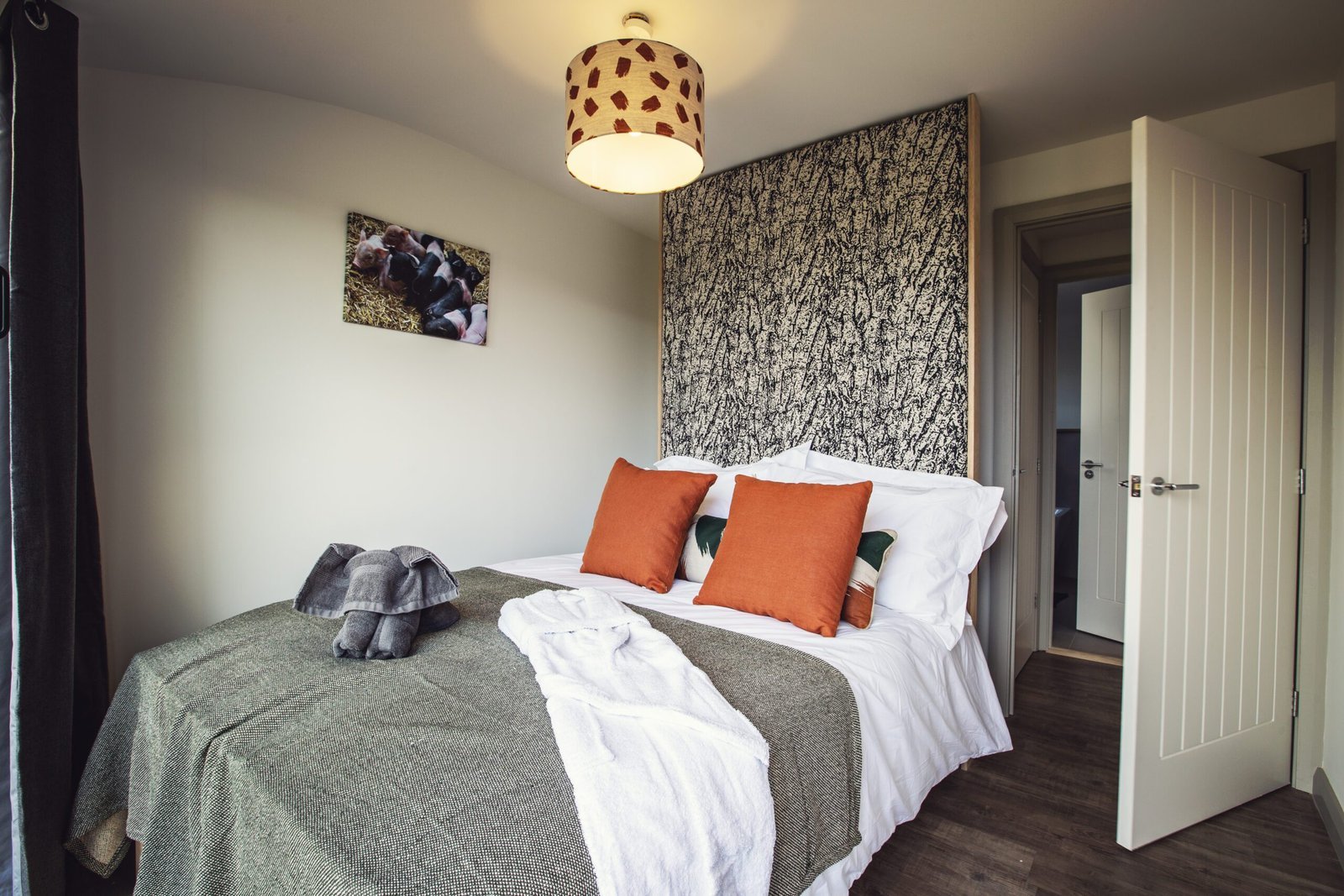 Cozy double bed in a modern cabin room with nature-themed decor