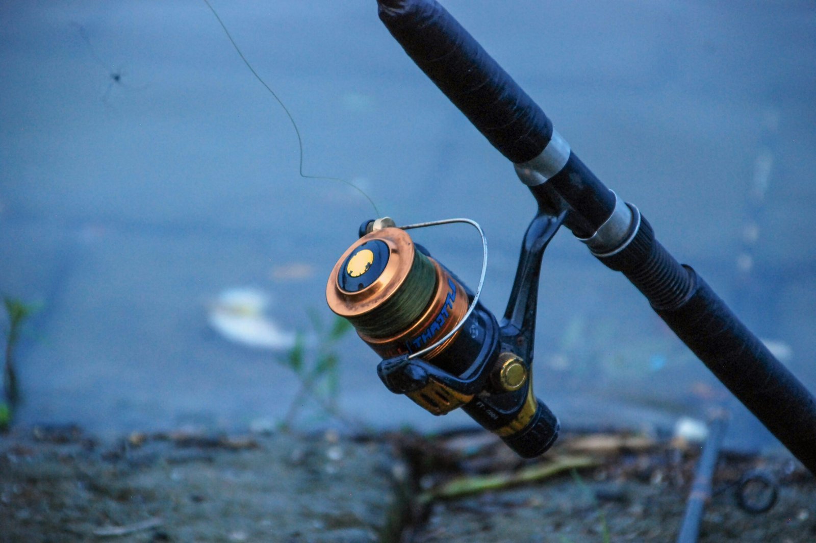 Fishing reel and rod by the water's edge on the River Wye